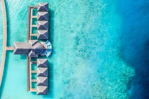 Aerial photo of beautiful paradise Maldives tropical beach on island. Summer and travel vacation concept in luxury resort or hotel. Perfect aerial landscape view, birds eye view