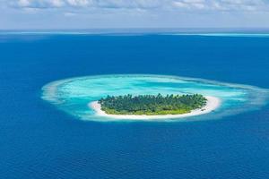 Aerial view of coral reefs in Maldives islands. Tropical aerial landscape. Luxury summer vacation and travel destination photo