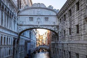 View of the famous Bridge of Sighs in Venice, Italy. Artistic urban landmark, soft sunset light photo