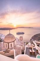 Great evening view of Santorini island. Picturesque spring sunset on the famous Greek resort Fira, Greece, Europe. Traveling concept background. Beautiful sunset landscape of famous vacation scenery photo