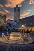 Fountain with tower in Piazza Vecchia in Bergamo photo