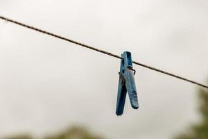 clothespin hanging on a rope photo