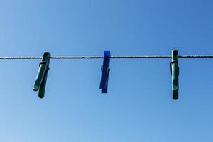 clothespins hanging on a rope photo