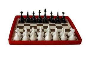 plastic chess board isolated on a white background. Travel chess. Selective focus. photo