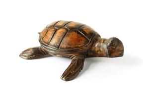 Wooden figurine of a sea turtle isolated on a white background. photo