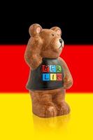 Bear symbol of Berlin. Bear on the background of the flag of Germany. photo