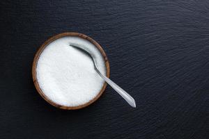 Sugar in wooden bowl. photo