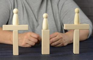wooden figures stand on the bridge from the sides opposite each other photo