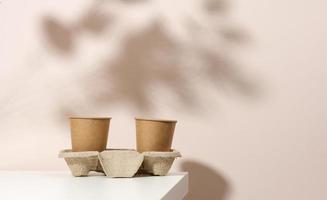 brown eco friendly disposable paper cups on a white table photo