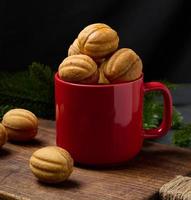 Baked nut-shaped dessert in a red ceramic mug photo