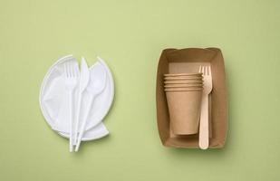 non-degradable plastic waste from disposable tableware and a set of dishes from environmental recycled materials photo