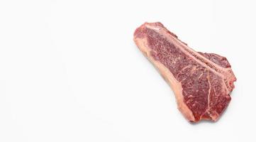 fresh raw piece of beef meat, striploin steakon white background.  Marbled piece of meat New York photo