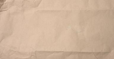 crumpled blank sheet of brown wrapping kraft paper photo