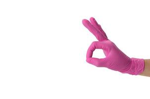 hand in pink medical glove shows ok gesture, white backgroundc photo