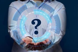 a woman in a striped shirt stands on a blue background, a holographic scheme and a question mark photo