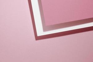 modern pink background with sheets of paper with shadow photo