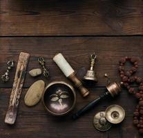 Tibetan singing copper bowl with a wooden clapper , objects for meditation and alternative medicine, top view photo