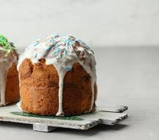 baked traditional Christian dessert for Easter holiday. The pastries are glazed and decorated with multi-colored sprinkles photo