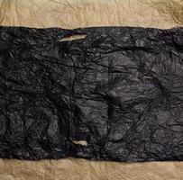 crumpled black and brown paper, abstract texture background photo