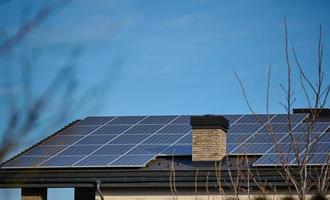 roof of a residential building with solar panels. Green energy and energy independence concept photo