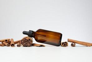 Brown glass bottle with a pipette on a gray background. Containers for cosmetics photo