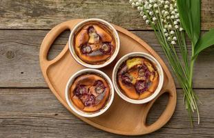 cottage cheese dessert baked in portioned round ceramic plates on a wooden table photo