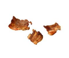 various small fried bacon pieces isolated on white background photo