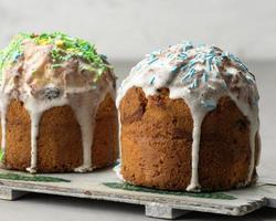 baked traditional Christian dessert for Easter holiday. The pastries are glazed and decorated with multi-colored sprinkles photo