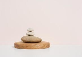 Stack of round stones on a white background. Scene for demonstration of cosmetic products, advertising photo