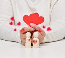 pair of wooden men of the bride and groom, red heart, concept of love and relationships photo