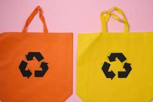 empty viscose eco friendly canvas tote bag for branding on a pink background. Clear reusable bag for groceries, mock up. Flat lay photo