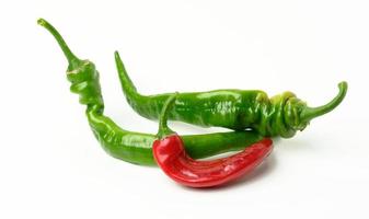 fresh pods of hot pepper on a white table. Hot spice photo