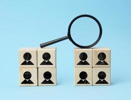 wooden cubes with staff black magnifier on blue background photo