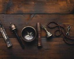 Tibetan singing copper bowl with a wooden clapper , objects for meditation and alternative medicine, top view. Plunging into a trance photo