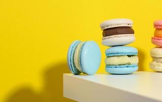 baked round macarons on a yellow background, delicious dessert photo