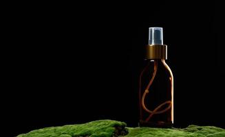 brown glass spray bottle stands on green moss photo