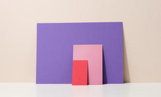 blank purple, pink cardboard sheet of paper with shadow on white table. Template for flyer, announcement photo