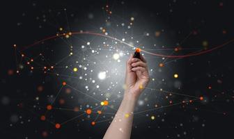 female hand holds a marker and draws connections in the structure of the global network for the exchange of information between users. Global business network concept photo