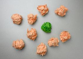 crumpled balls of paper on a gray background, top view. The concept of finding innovative ideas, the right solutions photo