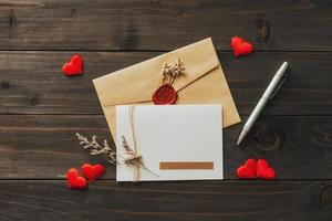 Valentine card with red heart on wooden background photo