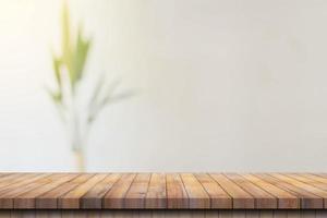 Wooden table top with blurred people in coffee shop and cafe background for display montage, copy space. photo