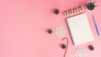 Notebooks with empty goals for 2023 year and phone on color background with copy space photo