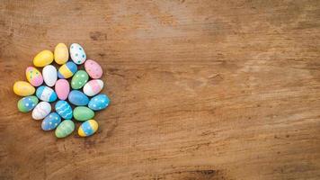 Colorful Easter Egg on a rustic old wood background. Above view with copy space. photo