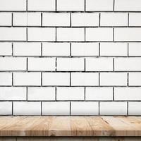 Empty wooden table top and white brick wall and rough crack background texture photo