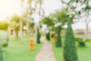 defocused bokeh and blur background of garden trees in sunlight with vintage toned. photo