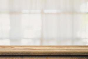 Wooden table top with blurred people in coffee shop and cafe background for display montage, copy space. photo