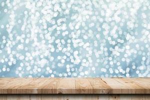 Abstract circular boken nigth and wood table for christmas background with space photo