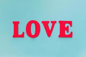 Love text on blue background with copy space photo