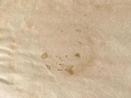 Close up old brown paper texture with coffee stained and background with copy space photo