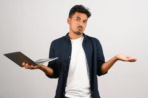 Portrait of a happy asian businessman working on laptop computer isolated over white background photo